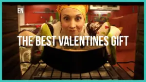 Woman in a colorful headscarf prepares a special dish in the oven, promoting thoughtful Valentine's gift ideas.