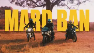 Three motorcyclists riding in an open field with bold text "MARD BAN" in the background during sunset.