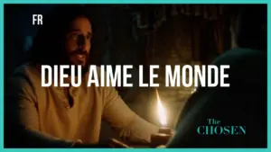 Scene from "The Chosen" featuring a man speaking warmly by candlelight, with text "Dieu aime le monde."