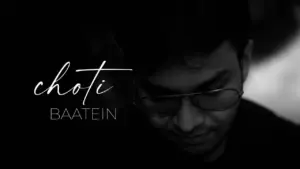 A thoughtful man with glasses in a black and white image, featuring the text "choti baatein" artistically displayed.