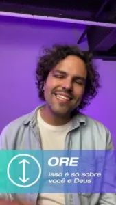 Smiling man with curly hair in casual attire, discussing faith in front of a purple backdrop with text overlay.