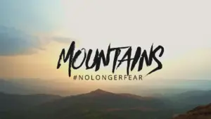 Stunning mountain landscape with a motivational hashtag #NOFEAR against a sunset backdrop, inspiring adventure and courage.