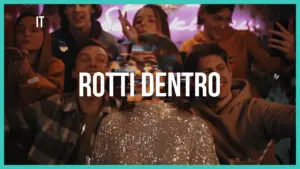 Group of friends celebrating at a lively party, illuminated by neon lights, featuring the bold text "ROTTI DENTRO."