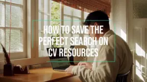 Person working on a laptop at a sunlit desk, focusing on saving searches for CV resources.