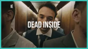 A man in a suit looks contemplative in an elevator, surrounded by others, with the phrase "DEAD INSIDE" prominently displayed.