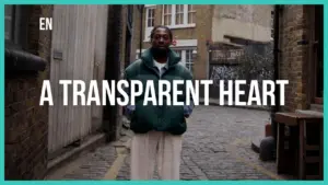 Man standing in a cobbled alley wearing a green jacket, with bold text overlay reading "A Transparent Heart."