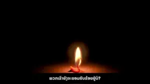 A single glowing candle flame flickering in the dark, casting soft light on the surface below.