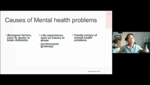 Presentation slide discussing causes of mental health problems, featuring bullet points on biological factors and life experiences.