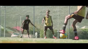 Young soccer players practicing on a sunny field, showcasing teamwork and skill during a training session.