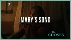 Woman singing in a dimly lit room, expressing deep emotion, with the title "Mary's Song" overlaying the scene from The Chosen.