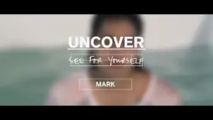 A person in soft focus against a blurred background with the text "UNCO" and "MARK" promoting discovery and authenticity.