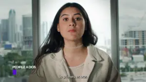 Young woman speaking in front of a city skyline, conveying a serious message in a contemporary setting.