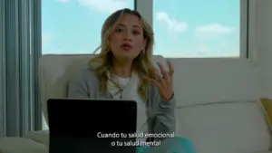 Woman discussing emotional and mental health while sitting on a couch with a tablet, bright window backdrop.