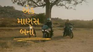 Two riders on motorcycles in a scenic landscape with a tree, showcasing adventure and freedom.