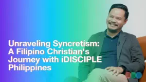 Filipino Christian smiling, discussing syncretism and iDISCIPLE Philippines, with a vibrant gradient background.