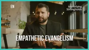 A man in a blazer discussing empathetic evangelism in a modern cafe setting with warm lighting and a welcoming atmosphere.