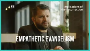 Man in a suit discussing empathetic evangelism with a focus on the implications of the resurrection in a bright setting.