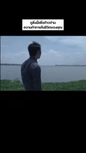 Person standing by a river gazing at the horizon under a blue sky, contemplating life and possibilities.