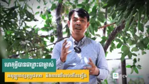 Man speaking amidst greenery, conveying a message about sustainable practices or community engagement.