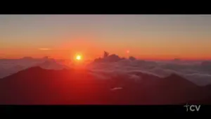 Breathtaking sunrise over mountains with a vibrant sky, clouds, and golden sunlight illuminating the landscape.