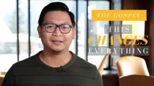 A man in glasses wearing a striped shirt stands against a bright window, promoting a message about the gospel's impact.