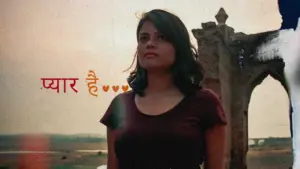 Young woman standing against a vintage backdrop with the text "प्यार है" artistically displayed nearby.